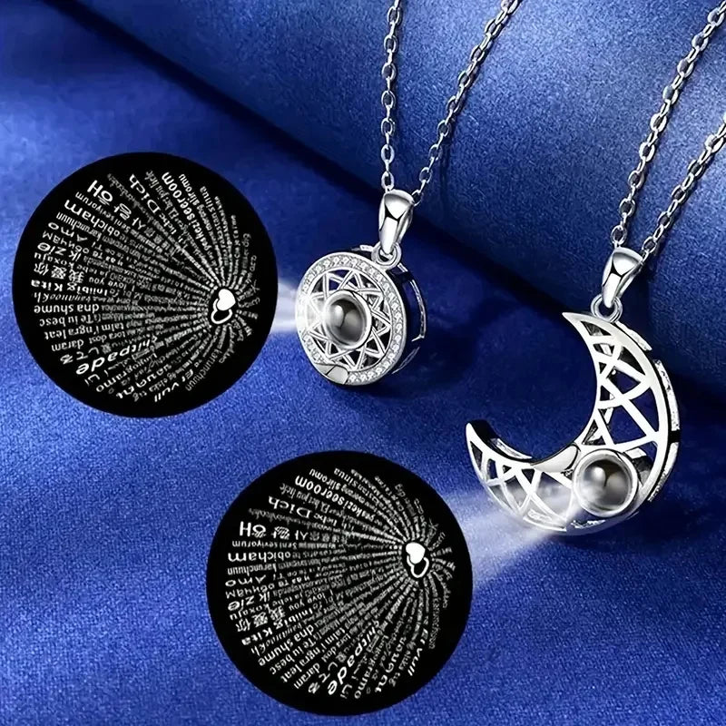 Silver necklaces with engraved designs on a blue fabric background